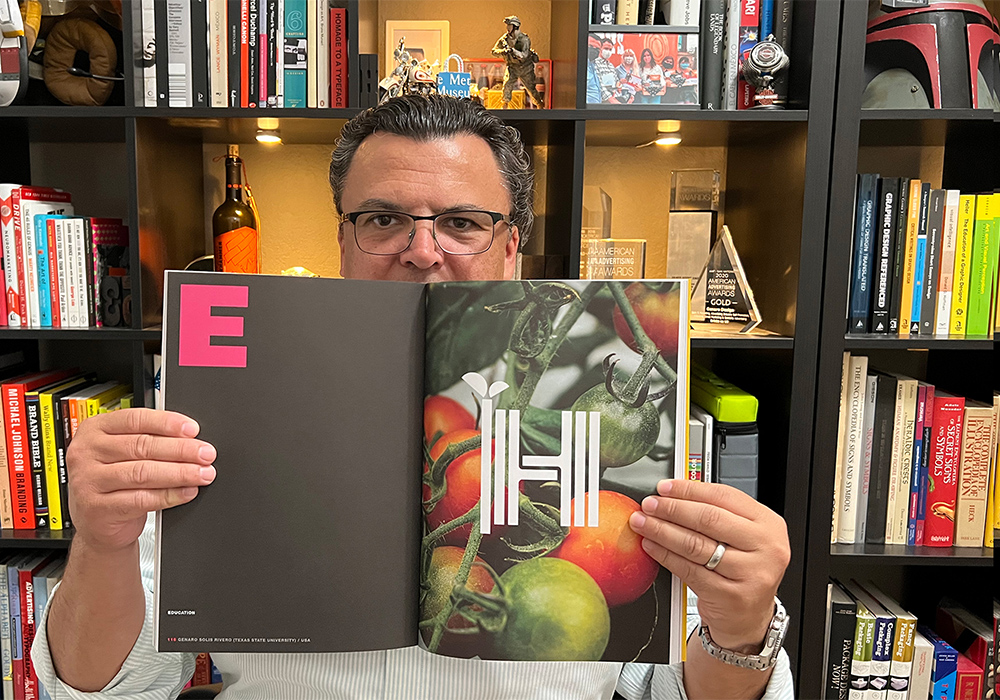 genaro holding a graphis journal